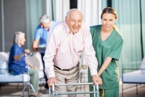 nurse helps elderly man with walker walk to an elder law lawyer in South Salem NY